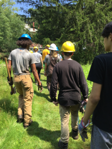 group of people in a line wearing hard hats