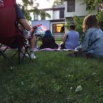 youth watching outdoor movie