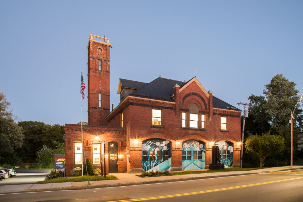 Renovated firehouse lit up at dusk